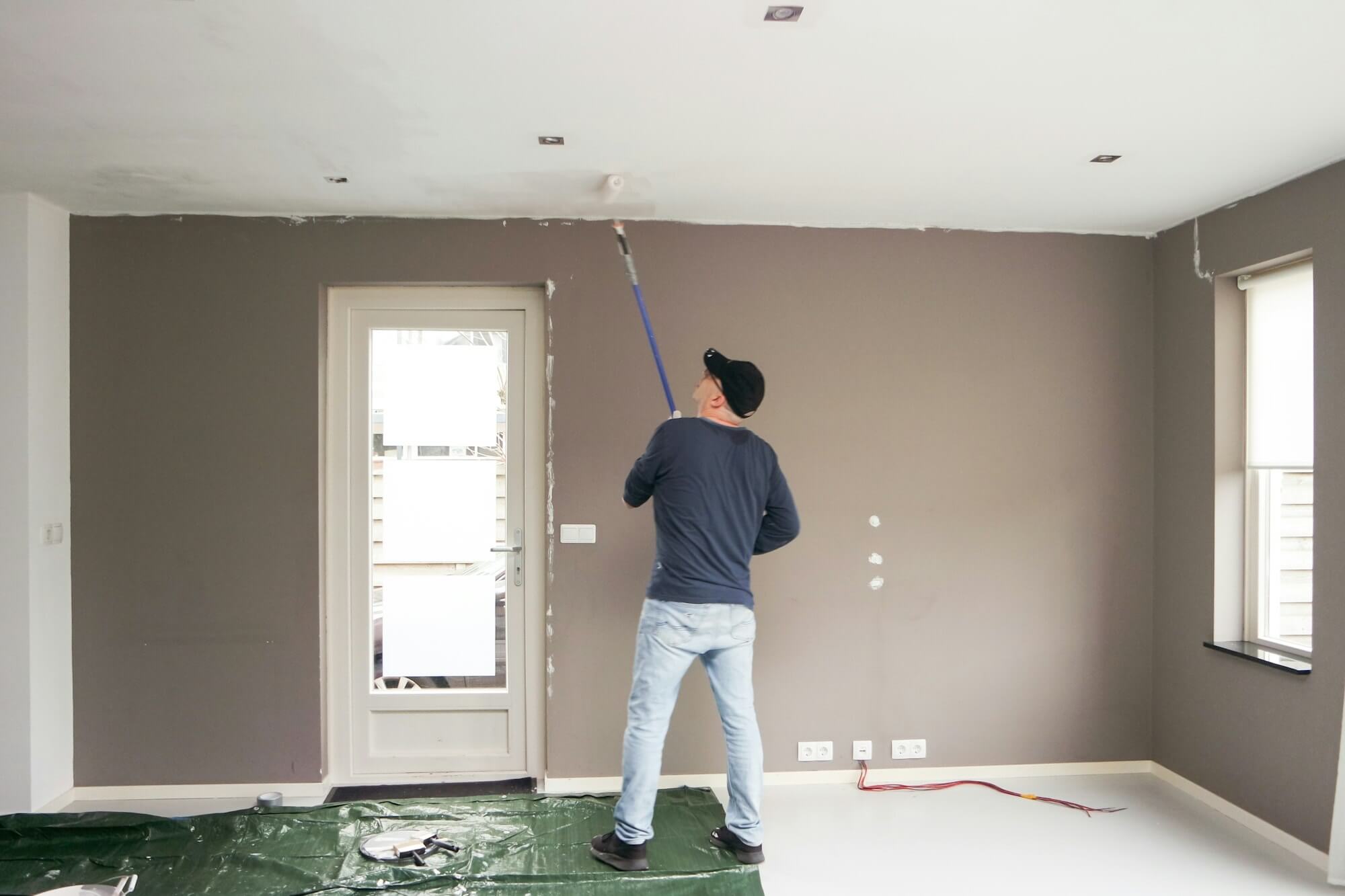 man-full-length-painting-the-ceiling-home-renovation-.jpg